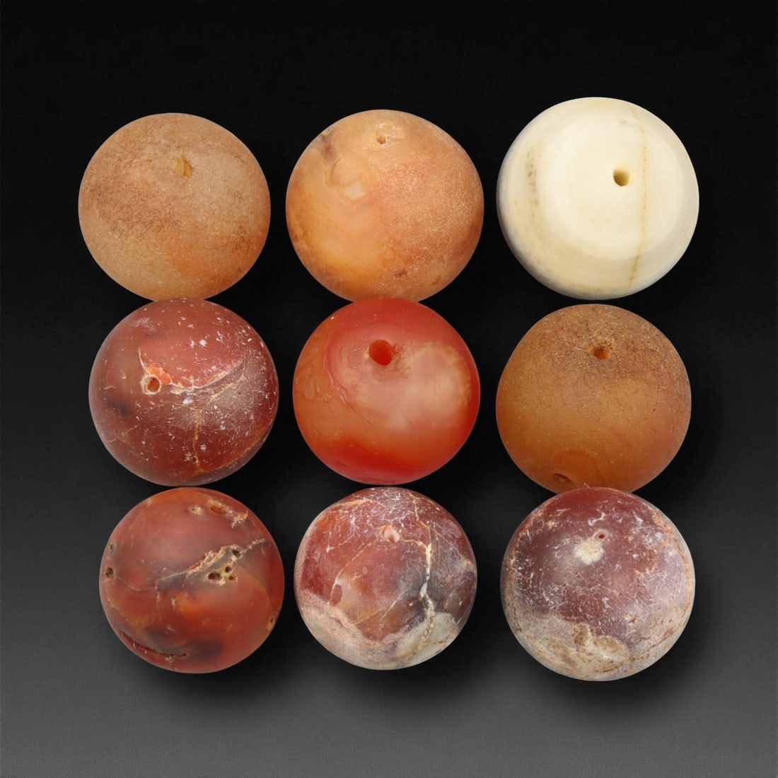 Antique Tibetan Carnelian and Agate Beads, c. 18th-19th Century, 1.9-2.4cm, 79EF: This fine group of antique Tibetan beads, carved from carnelian and agate, dates to the 18th-19th century. Each spherical bead displays unique natural banding and earthy translucence, ranging in color
