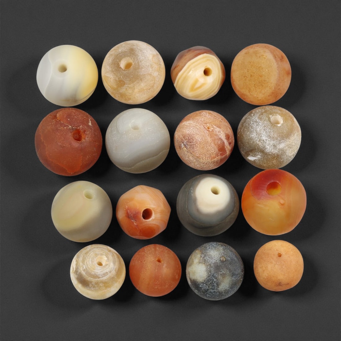 Antique Tibetan Agate and Chalcedony Prayer Beads Collection, c. 18th-19th Century, 1.2-1.5 cm, 8EM: This graceful assemblage of antique Tibetan beads, carved from agate and chalcedony, dates to the 18th-19th century and embodies the quiet spiritual refinement of Himalayan craftsmanship. Each bead is