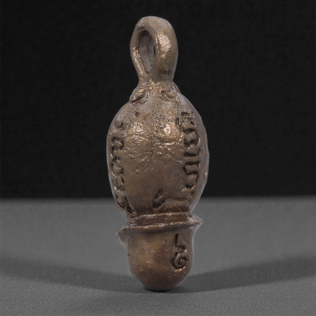 Thai Bronze Phallic Fertility Amulet - Folk Erotic Talisman, 75Q: This small Thai bronze amulet is cast in a strongly stylized phallic form, created as a folk fertility and potency charm rather than a religious icon. The rounded upper body transitions into a compact
