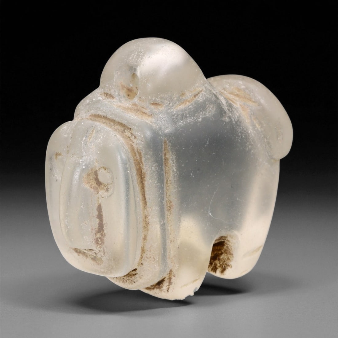 Ancient Medieval Coptic Egyptian Zoomorphic Glass Amulet, c. 11th-13th Century CE, 3.8cm, 18ER: This remarkable zoomorphic amulet, carved from translucent glass with a milky crystalline sheen, dates to the Coptic Egyptian period of the Medieval era, circa 11th-13th century CE. Its compact form, 