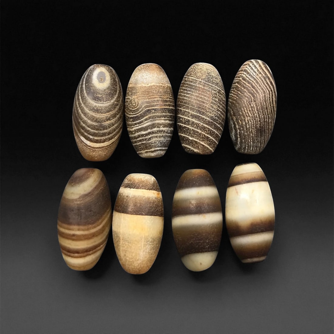 Antique Tibetan Banded Agate Beads, c. 18th-19th Century, 1.5-1.7 cm, 54EL: This refined group of eight antique agate beads originates from Tibet, dating to the 18th-19th century. Each bead displays beautifully natural banding and soft surface weathering, testifying to both g