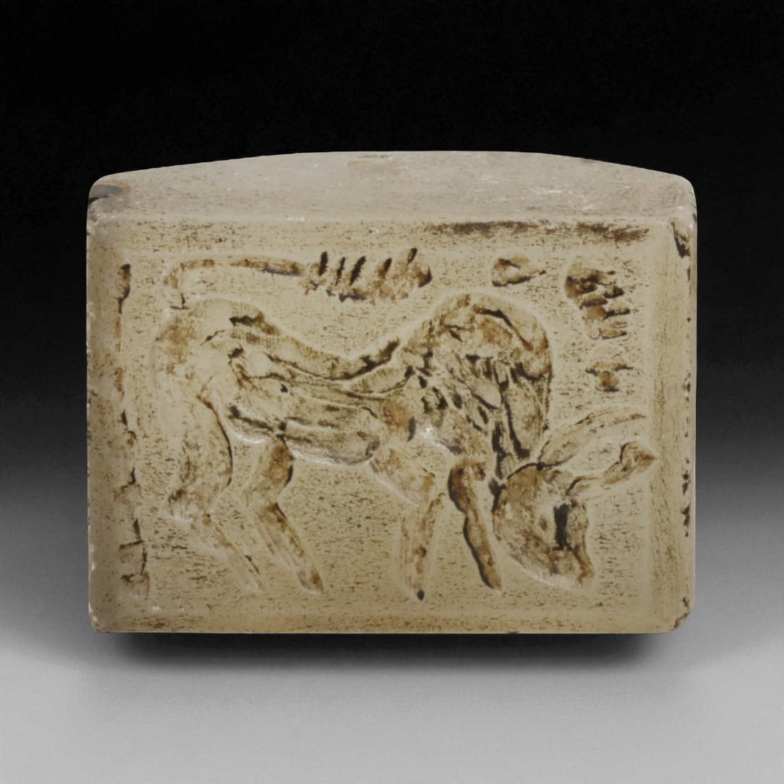 Ancient Sasanian Chalcedony Block Stamp Seal with Bovine Motif, c. 3rd-6th Century CE, 54g, 98LG: This substantial chalcedony block stamp seal, dating to the Sasanian Empire (c. 224-651 CE), weighs 54 grams and measures 3.8 x 2.7 cm. Its engraved surface depicts a powerful bovine, head lowered in 