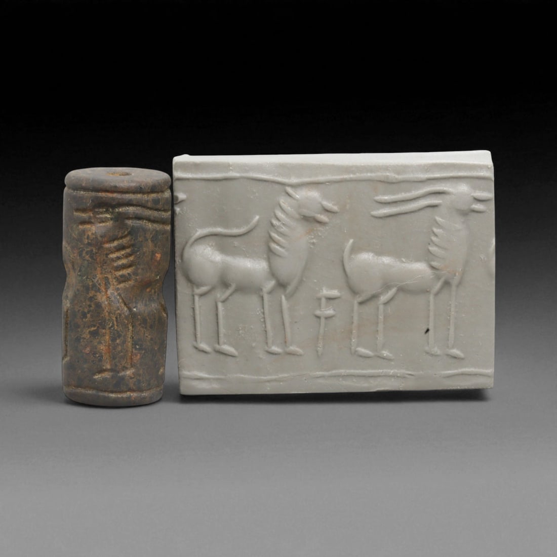 A Mesopotamian Stone Cylinder Seal, 3rd-2nd Millennium BCE, 2.5cm, 44BE: This authentic cylinder seal from ancient Mesopotamia dates to the 2nd to 1st millennium BCE, a time when the art of carving miniature narratives on stone reached remarkable levels of refinement. Seal