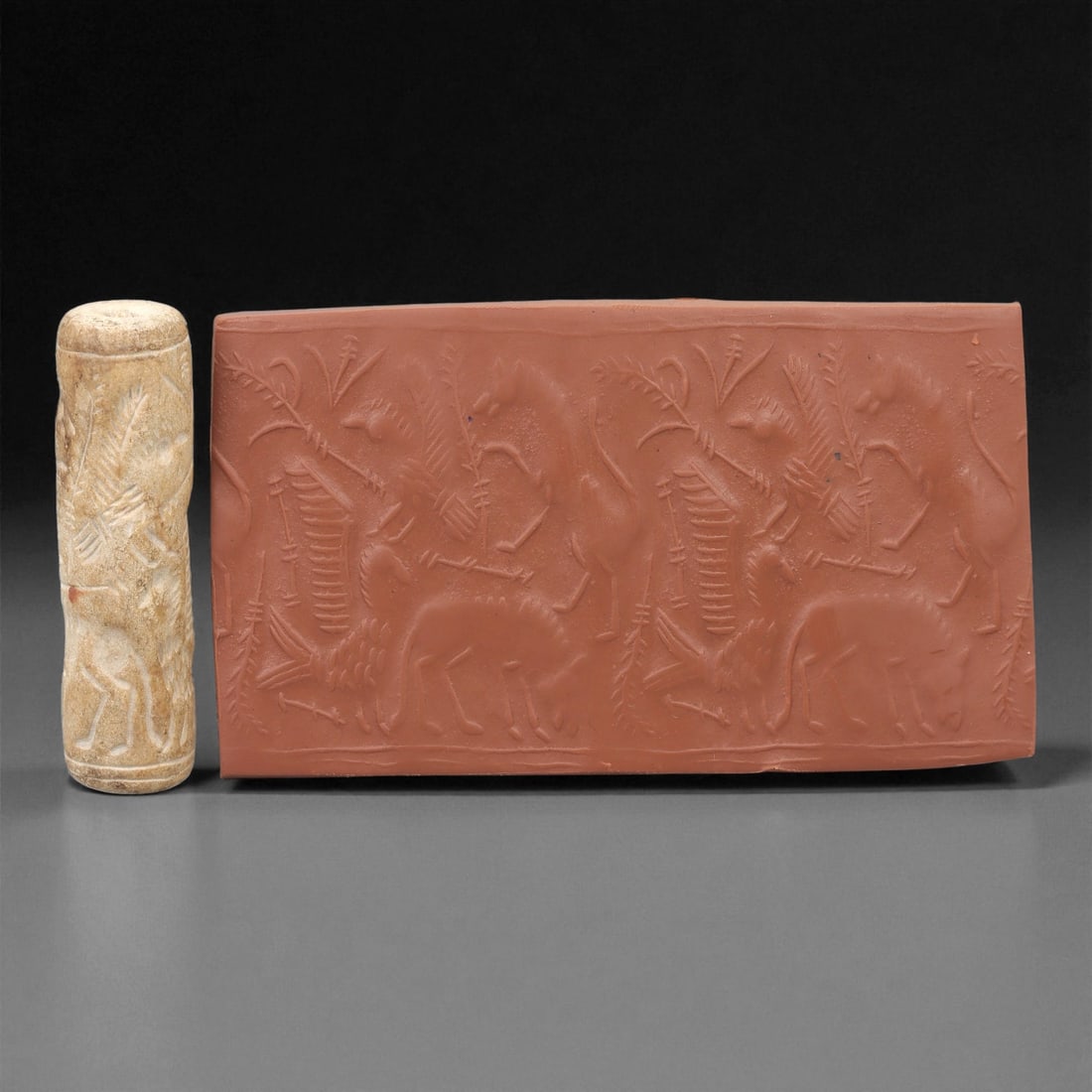 A Near Eastern Stone Cylinder Seal, 2nd-1st Millennium BCE, 11LE: Carved from a light beige stone with surface mottling, the cylindrical seal is engraved in shallow intaglio with a continuous scene of opposed quadrupeds and stylised hybrid creatures arranged among v
