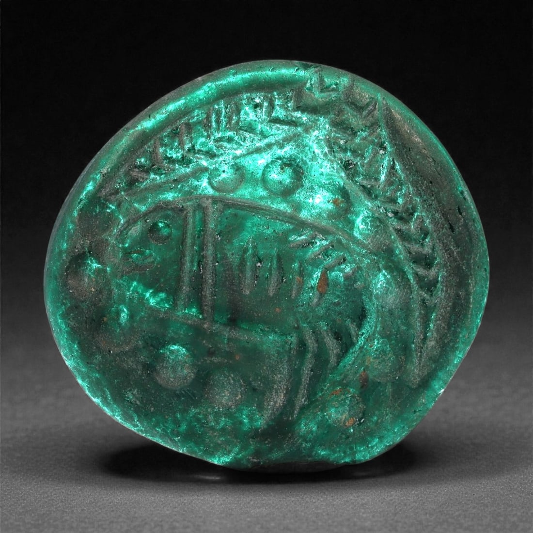 An Early Islamic Molded Green Glass Roundel with Fish Motif, 8th-10th Century CE, 17LP (1 of 3)