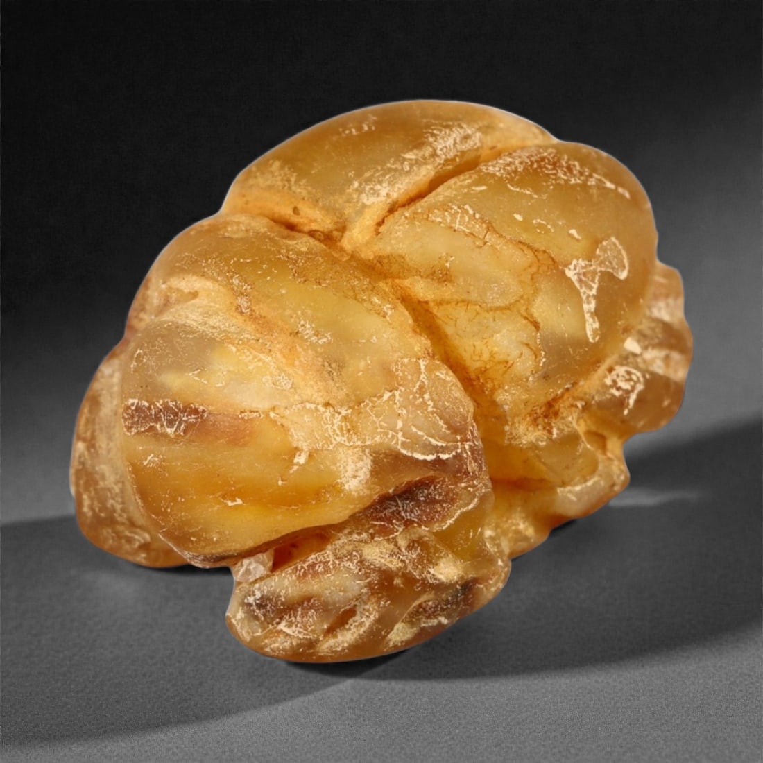 An Egyptian Schist Scarab Amulet, New Kingdom, 16thEUR"11th Century BCE, 7A: Carved from light brown schist, the amulet is shaped as a scarab with the upper surface defined by a domed carapace segmented by shallow longitudinal and transverse grooves. The underside is plain and