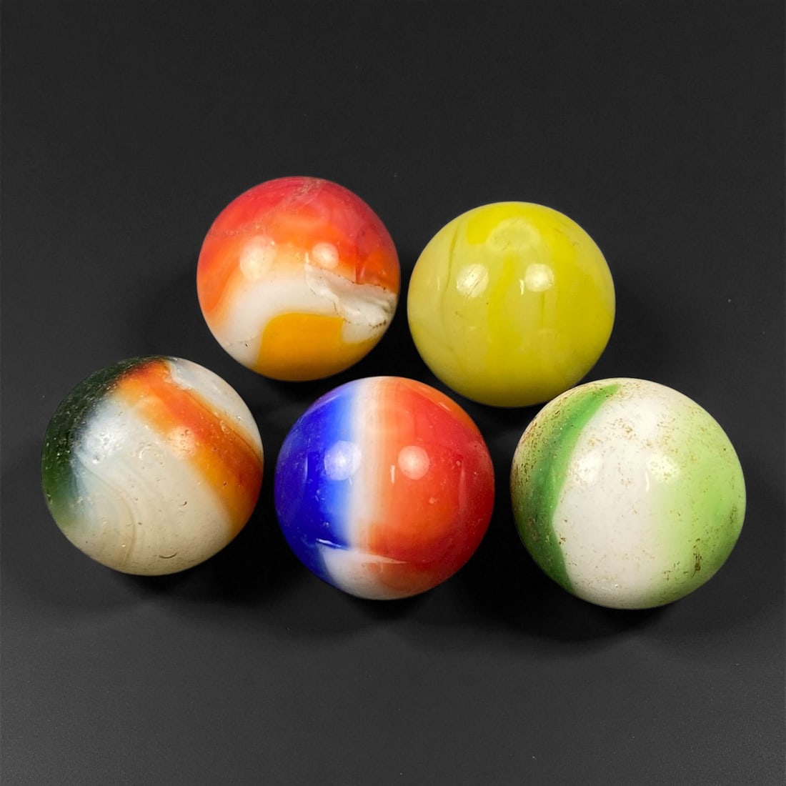 Vintage Glass Marbles Lot, Mid-20th Century, 1.5cm, 100EK: This charming lot of vintage glass marbles, dating from the mid-20th century, reflects the artistry and playfulness of early handmade and molded glass craftsmanship. These marbles were produced during