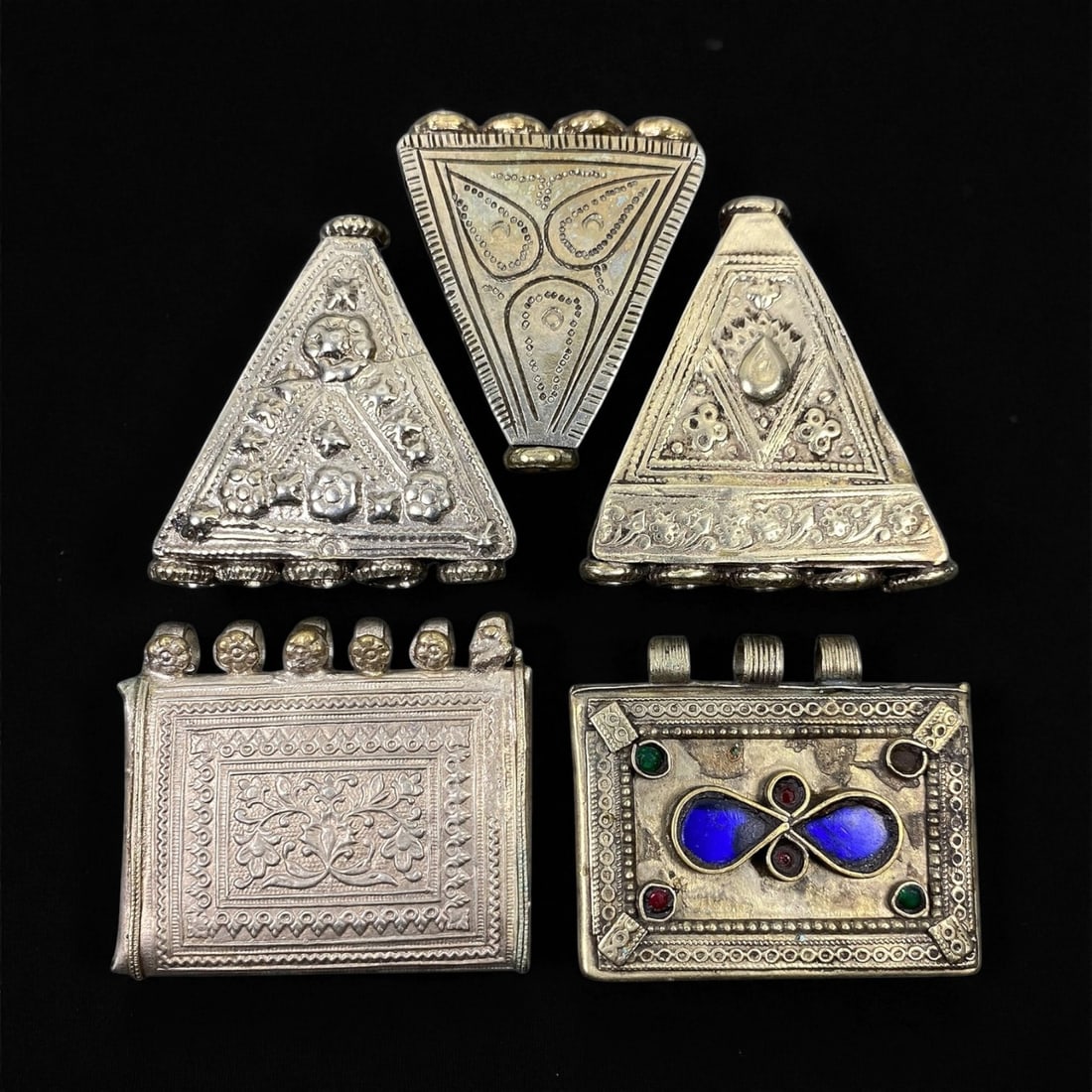 Antique Himalayan Silver Alloy Amulet Box Pendants Set, c. 19th-20th Century, 4.8-4.9 cm, 83EC: This captivating set of five antique Himalayan amulet boxes, dating to the 19th-20th century, represents the region's deep spiritual and artistic heritage. Crafted in silver alloy and richly adorned w