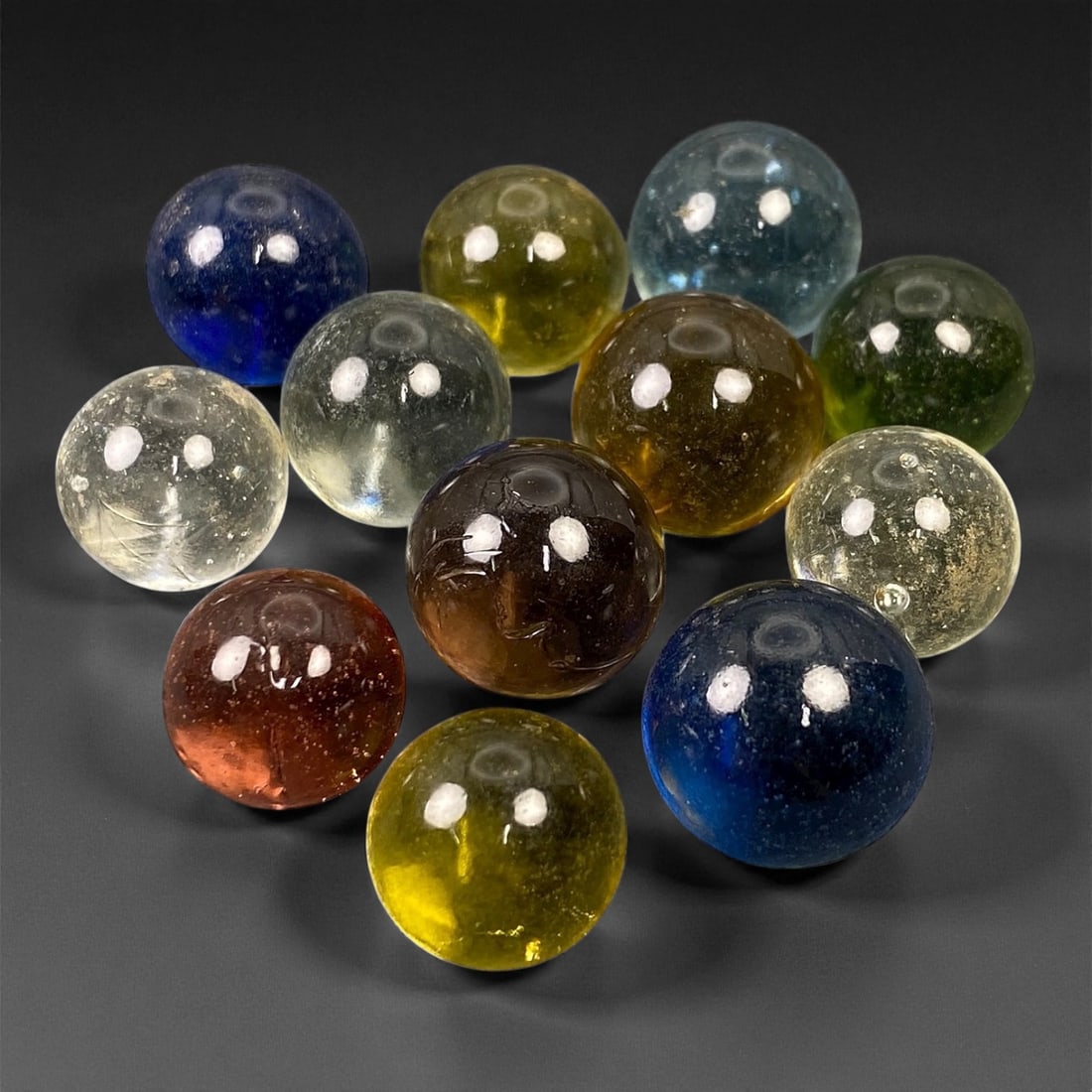 Vintage Glass Marbles Lot, Mid-20th Century, 1.4-1.6cm, 48EK: This charming lot of vintage glass marbles, dating from the mid-20th century, reflects the artistry and playfulness of early handmade and molded glass craftsmanship. These marbles were produced during