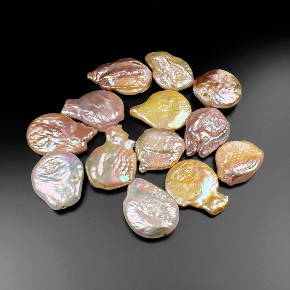 31.87 Grams Iridescent Multicolor Keshi Pearl Selection - Natural Freshwater Cultured Lot, 43WA: This luminous selection of cultured freshwater keshi pearls showcases a captivating array of natural iridescence, blending soft pink, golden, and silvery overtones with opalescent surface reflections.