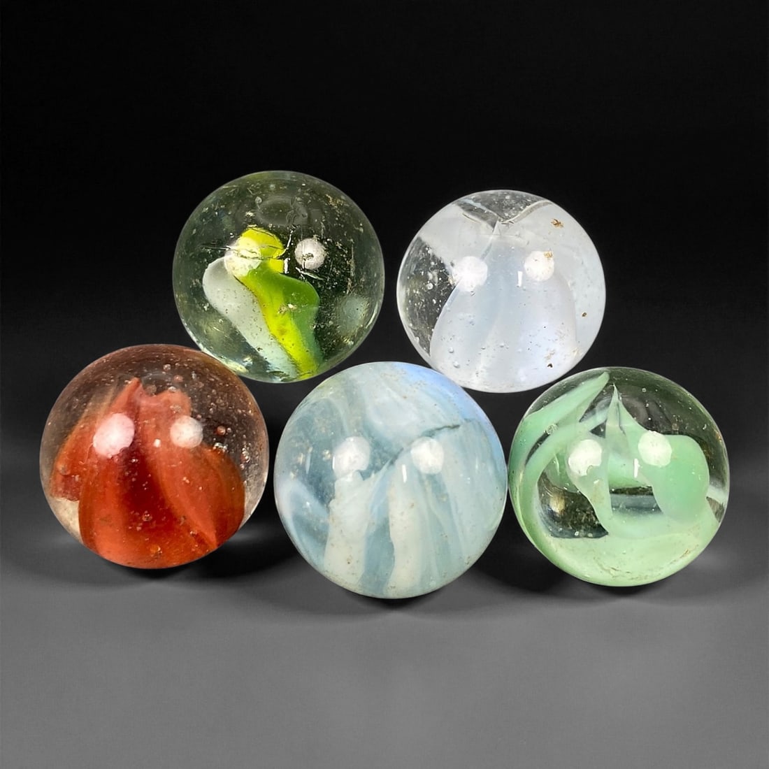 Vintage Glass Marbles Lot, Mid-20th Century, 1.5-1.6cm, 90EK: This charming lot of vintage glass marbles, dating from the mid-20th century, reflects the artistry and playfulness of early handmade and molded glass craftsmanship. These marbles were produced during