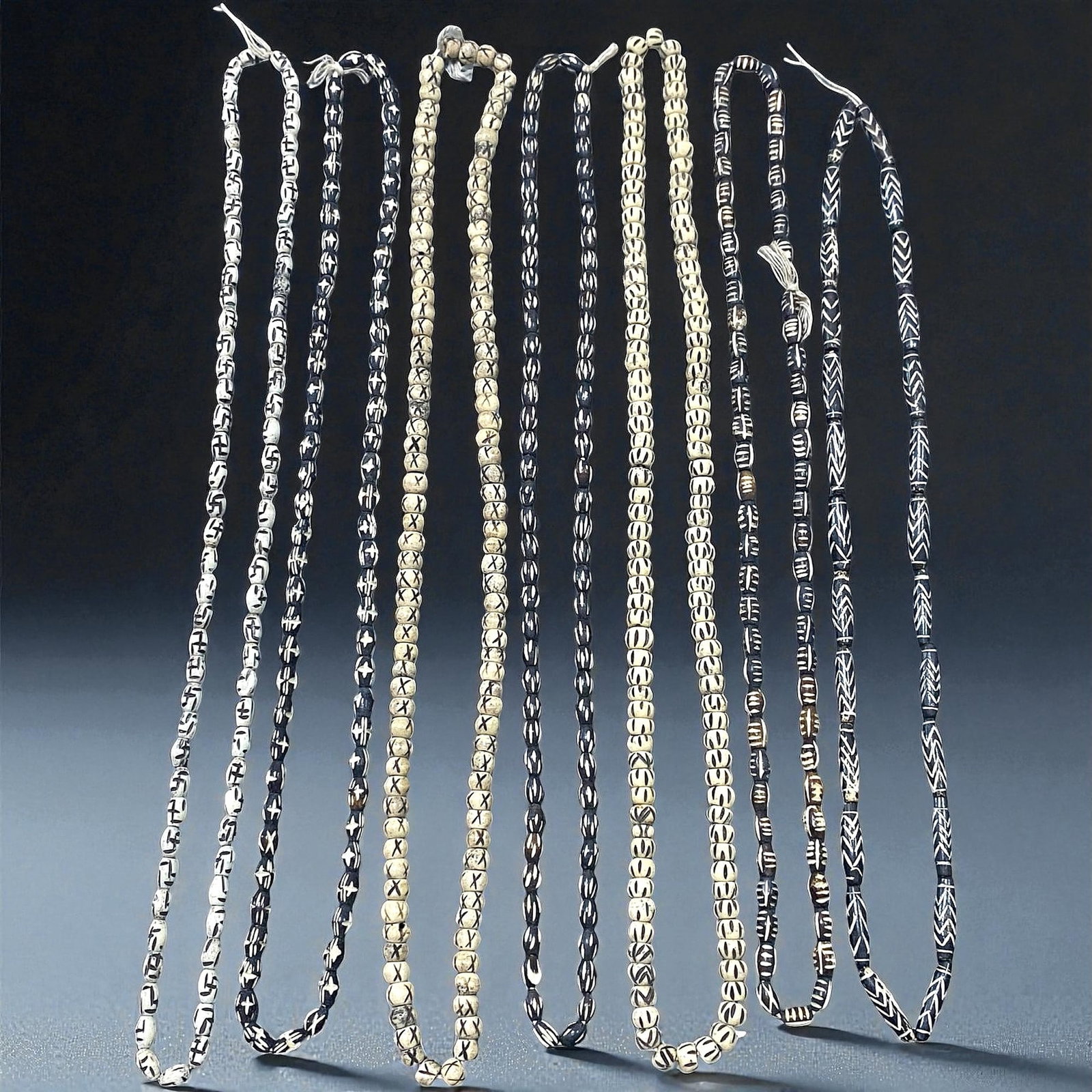 Vintage Himalayan Etched Bone Prayer Bead Strands, c. 20th Century, 7 Strands, 39EX: This set of seven vintage Himalayan bead strands showcases the enduring artistry of Nepalese and Tibetan carvers during the 20th century. Each strand is composed of hand-carved bone beads decorated wi