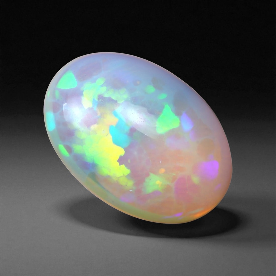4.89 Carats Multicolor Opal Selection - Natural Welo Ethiopian Stones, 77XB: This luminous selection of Welo opals dazzles with vibrant play-of-color, ranging from electric greens and cobalt blues to sunlit oranges and flashes of violet. Each cabochon has been hand-selected fo