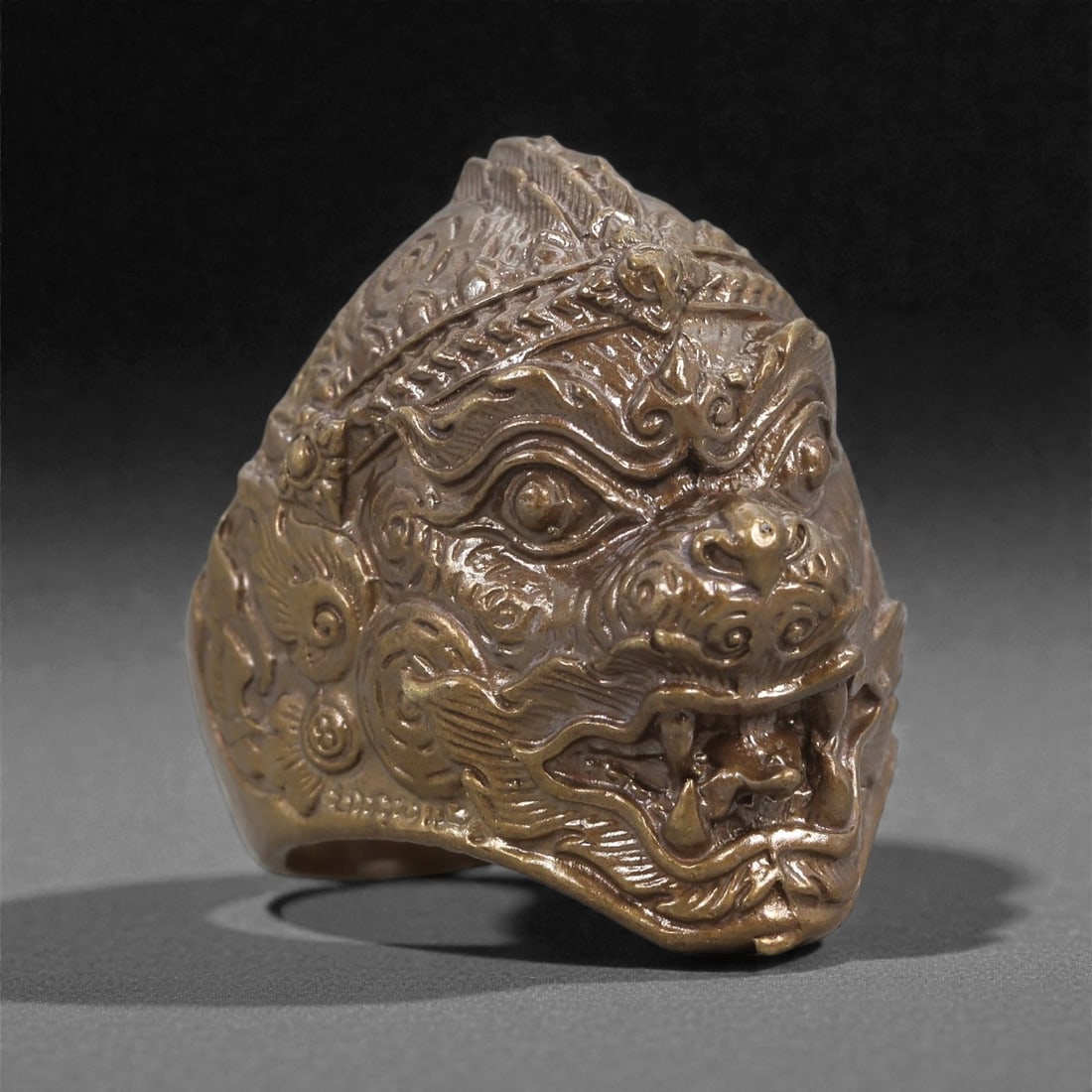 Bronze Mythic Beast Ring - East Asian Protective Icon, 31D: Cast in bronze with a dense, polished surface, this ring features a boldly sculpted mythic beast head forming the bezel. The creature is rendered with pronounced eyes, layered brows, curling whiskers,