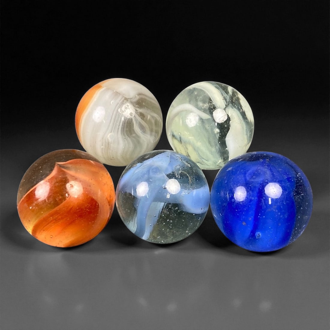 Vintage Glass Marbles Lot, Mid-20th Century, 1.5-1.6cm, 73EK: This charming lot of vintage glass marbles, dating from the mid-20th century, reflects the artistry and playfulness of early handmade and molded glass craftsmanship. These marbles were produced during