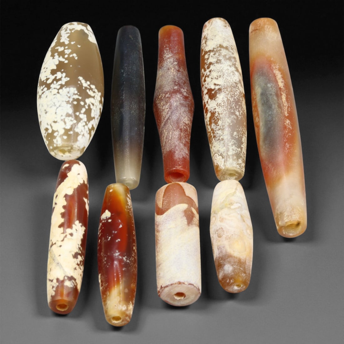 Ancient Persian Long Biconical Agate and Chalcedony Beads Set, c. 550-330 BCE, 3-6.6 cm, 4EB: This distinguished collection of elongated biconical and cylindrical beads dates to the Achaemenid Persian Empire, c. 550-330 BCE, a period that epitomized elegance, precision, and spiritual symbolism