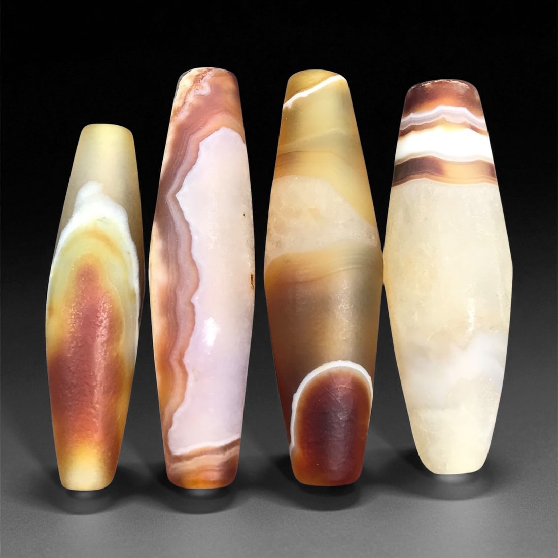 Ancient Persian Banded Agate Barrel Beads c. 1st Mill BCE 3.4-4cm, 59ER: These ancient Persian agate beads embody the lapidary sophistication that flourished across early Iranian cultures during the 1st millennium BCE. Their elongated barrel forms highlight the natural ban