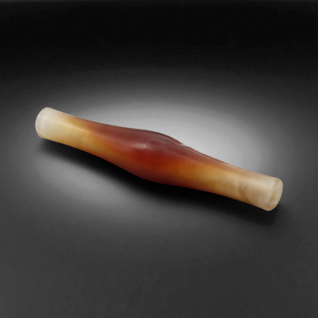 Ancient Near Eastern Carnelian Biconical Bead, c. 21st-18th Century BC, 6.3cm, 7g, 50M: This elegant carnelian bead, originates from the Early Bronze to Middle Bronze Age, dating to the 21st-18th century BC. Likely produced in the region of Tepe Marlik or Amlash in northwestern Iran, it