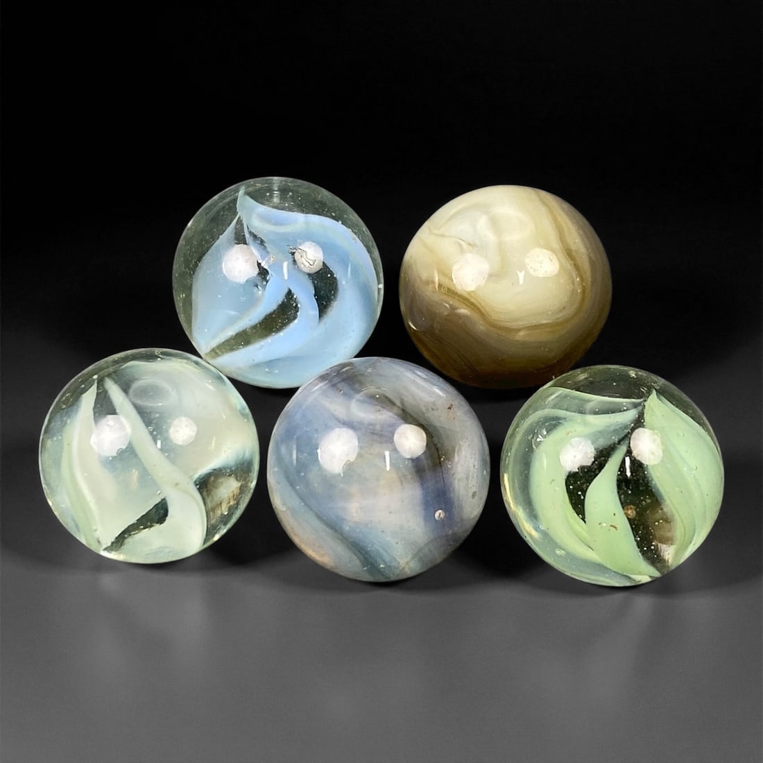 Vintage Glass Marbles Lot, Mid-20th Century, 1.5cm, 60EK: This charming lot of vintage glass marbles, dating from the mid-20th century, reflects the artistry and playfulness of early handmade and molded glass craftsmanship. These marbles were produced during