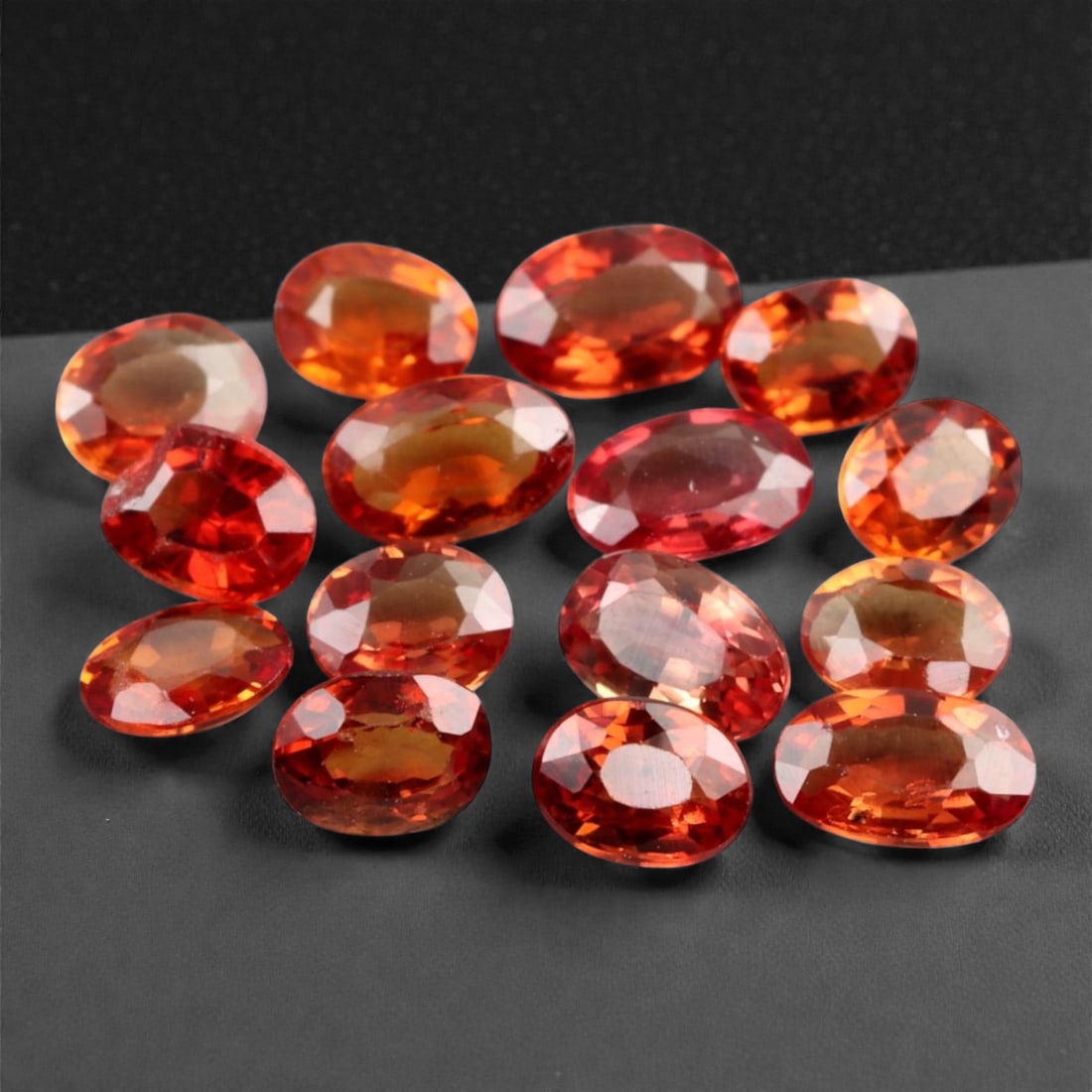 3.37 Carats Golden-Orange Faceted Songea Sapphire Parcel - Natural Tanzanian Stones, 57XB: This vibrant parcel of Songea sapphires glows with a fiery palette ranging from deep amber and burnt orange to bright golden honey tones. Each gem, averaging 4.6x3.0x1.6 mm, is expertly faceted to max