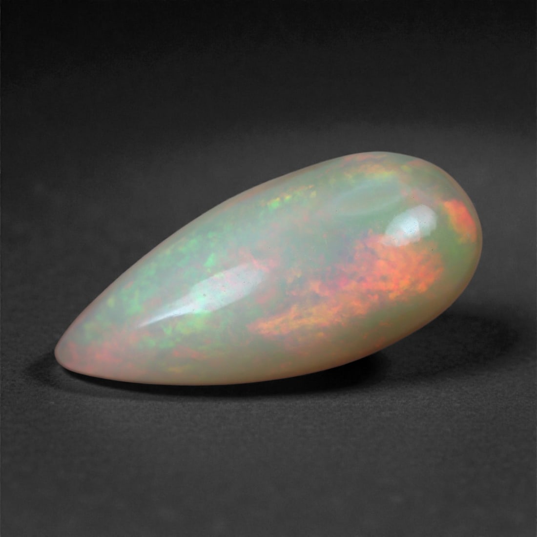 3.33 Carats Play-of-Color Welo Opal - Natural Ethiopian Gem 17x7mm, 51XA: This captivating Welo opal gleams with a luminous cascade of multi neon color that ripple across the stone's surface with every movement. The play-of-color is vivid and well-distributed, presenting a 