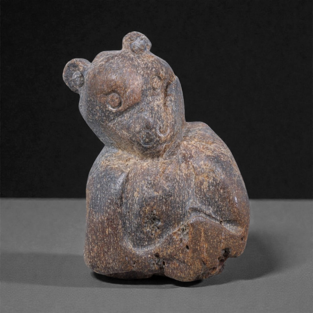 Ancient Fossil Bone Stone Anthropomorphic Figurine - Abstract Human Form, 3F: This compact anthropomorphic figurine is carved from dense fossilized bone stone and represents a stylized human form rendered in a highly abstract, archaic manner. The figure stands upright with a ro