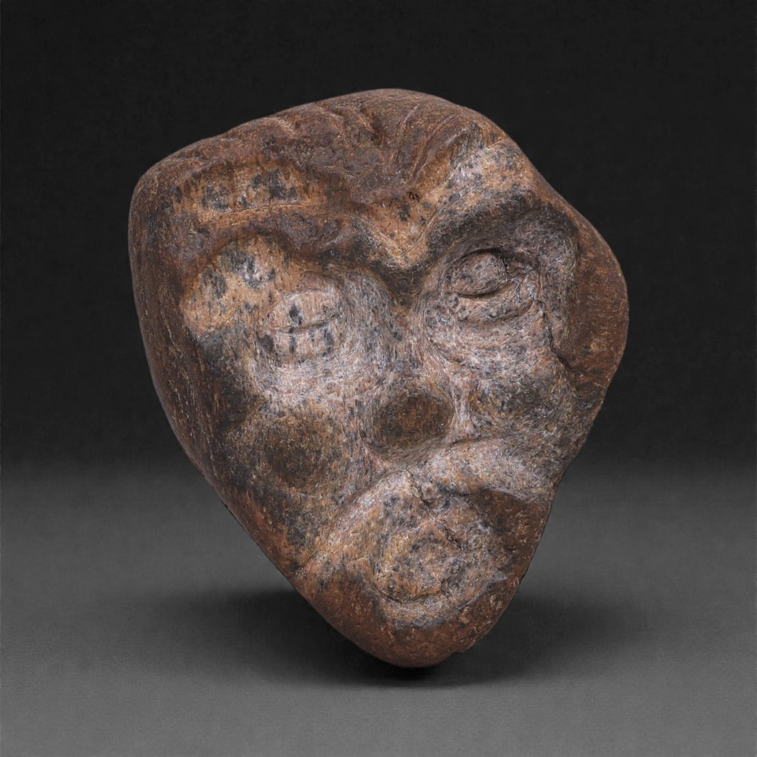 Ancient Fossilized Bone Stone Anthropomorphic Face - Near Eastern Figurine 4.5cm, 17ZD: Carved from fossilized bone stone, this small anthropomorphic face is rendered in a compact, mask-like form with deeply modeled eyes, a broad nose, and a pronounced mouth, the facial features emerging
