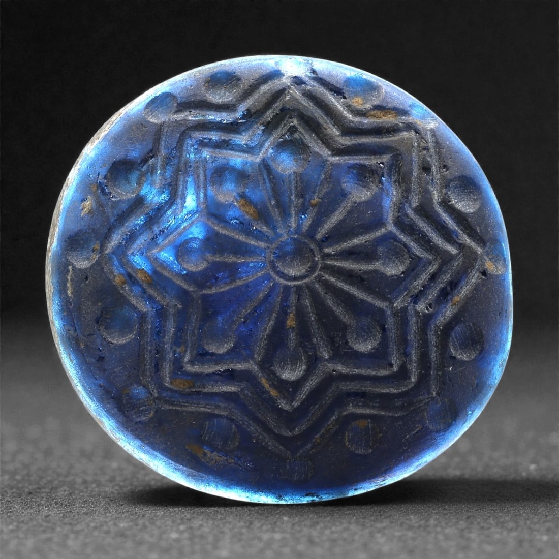 An Early Islamic Molded Blue Glass Roundel with Star-Rosette, 8th-10th Century CE, 23LP (1 of 4)