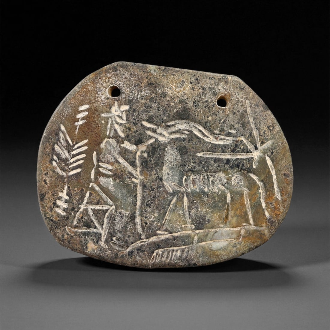 A Proto-Elamite Ibex and Palm Motif Steatite Plaque Amulet, c. 30th-27th Century BCE, 8cm, 19ES: This elegantly engraved steatite plaque amulet dates to the Proto-Elamite period of southwestern Iran, one of the earliest civilizations to emerge alongside Sumer. Its imagery-an ibex standing before