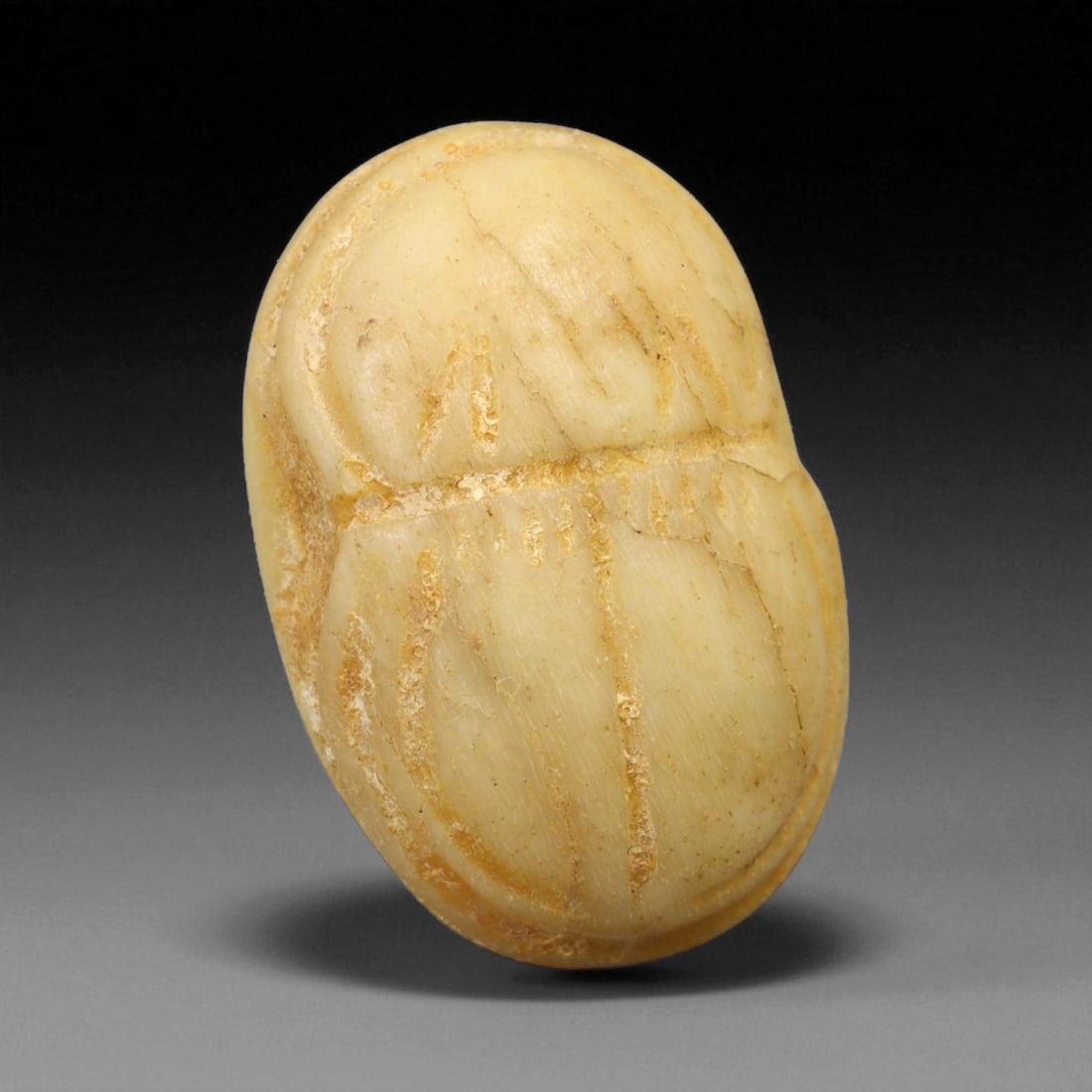 Ancient Egyptian Bone Scarab Amulet, c. New Kingdom 16th-11th Century BCE 2.6g, 63BG: This small but finely shaped scarab amulet, carved from bone, originates from ancient Egypt's New Kingdom period, c. 16th-11th century BCE. Measuring 2 cm and weighing 2.6 g, the piece takes the famil