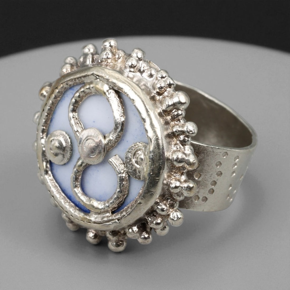 Antique Central Asian Blue Enamel Silver Tribal Symbol Ring, c. 19th-20th Century, US Size 7.5, 65BA: This striking antique silver ring embodies the decorative and spiritual language of Central Asian tribal craftsmanship from the late 19th to early 20th century. The round face features a central blue