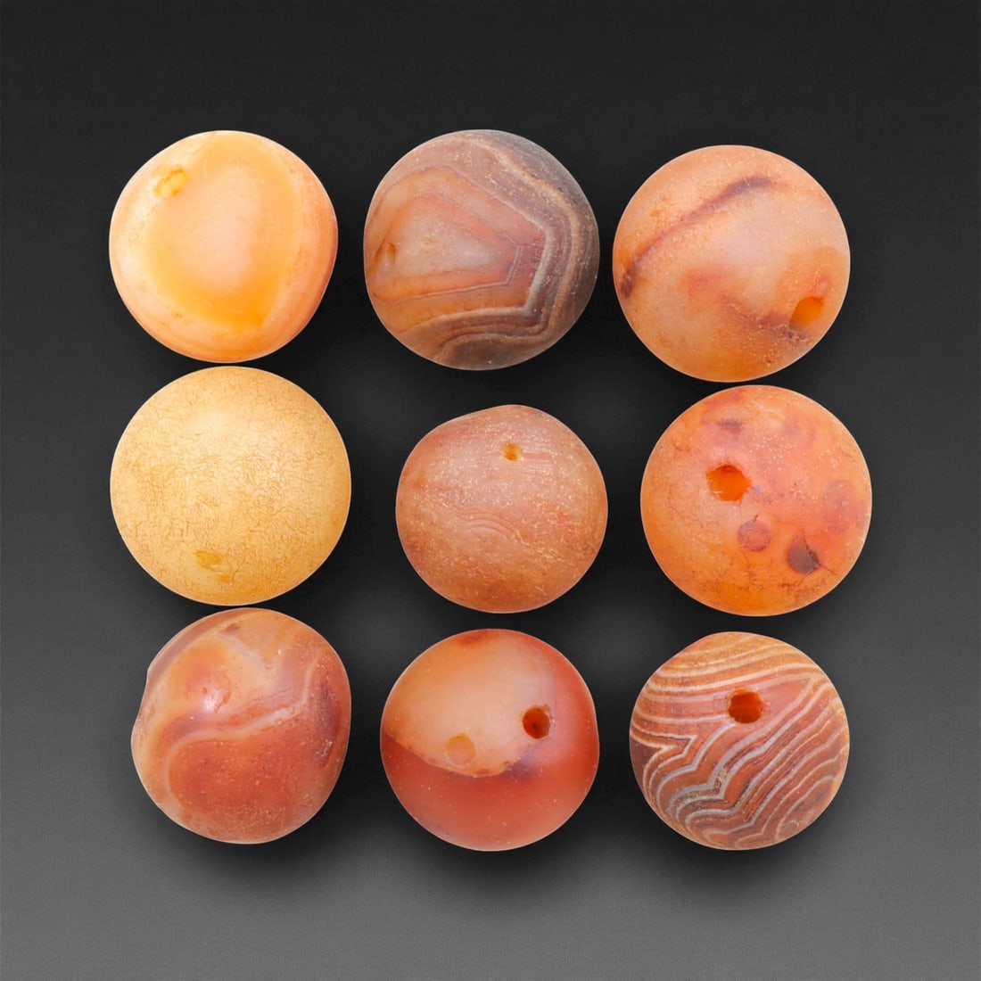 Antique Tibetan Carnelian Beads Collection, c. 18th-19th Century, 1.3-1.5cm, 88EL: This collection of antique Tibetan carnelian beads, dating to the 18th-19th century, exemplifies the spiritual and artisanal refinement of Himalayan lapidary traditions. Each bead, hand-shaped from na