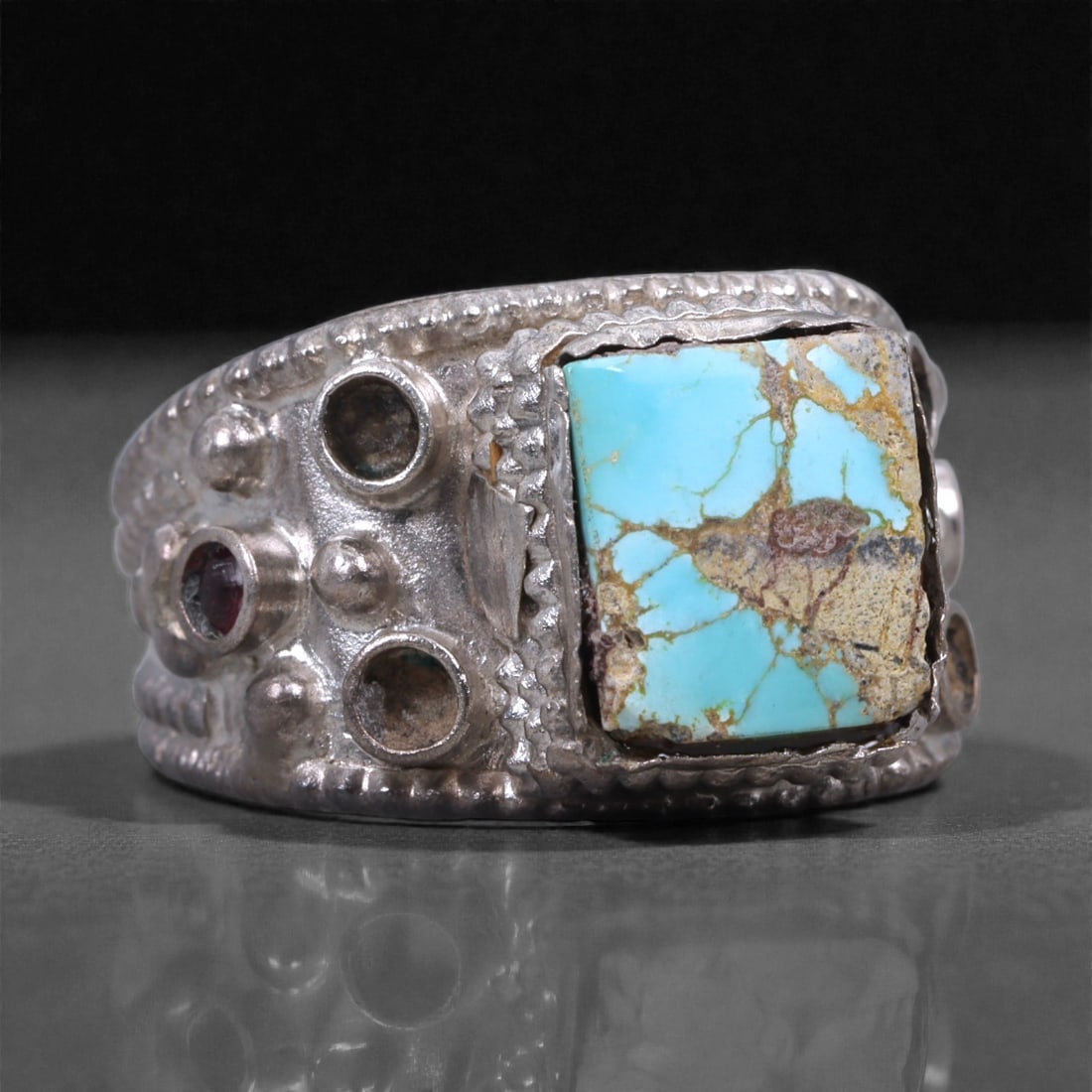 Silver Turquoise Ring - Rectangular Cabochon Design, 55X: The ring is made in solid silver with a broad, heavy band and a substantial rectangular bezel. Set at the center is a natural turquoise stone showing a bright blue field crossed by tan and brown matri