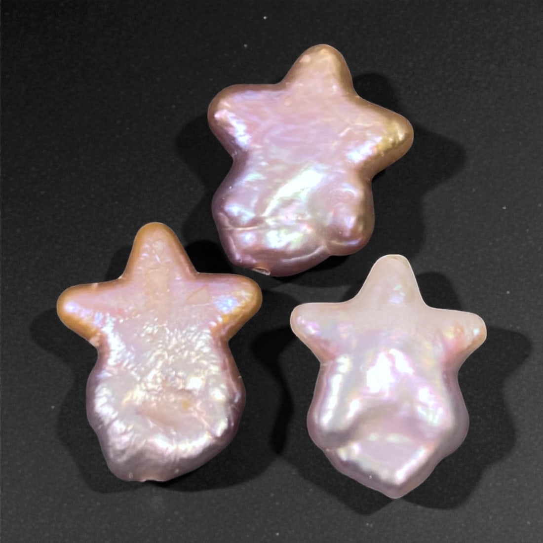 12.75 Carats Star-Shaped Keshi Pearl Trio - Natural Freshwater Formation 14-15mm, 52XC: This whimsical trio of star-shaped keshi pearls offers a playful twist on organic beauty, with each piece shimmering in a medley of rose, lilac, and champagne overtones. Measuring 14-15mm each, these 