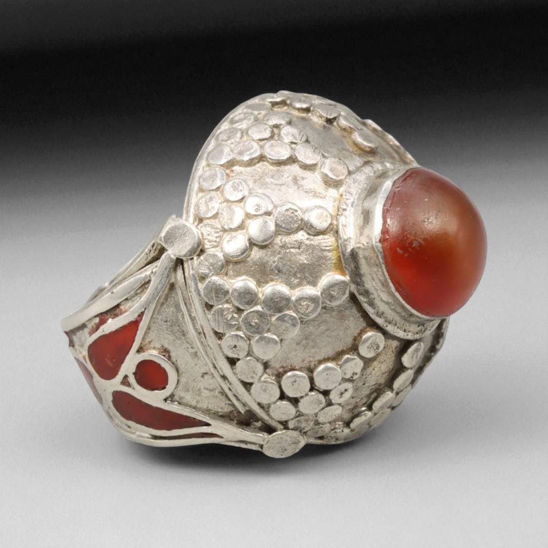 Antique Central Asian Granulated Carnelian Dome Silver Ring, c. 19th-20th Century, US 6.5, 7BD: This bold and sculptural antique ring exemplifies the granulated silverwork of Central Asia's late 19th to early 20th century artisan tradition. Its domed bezel cradles a deep red carnelian cabochon,