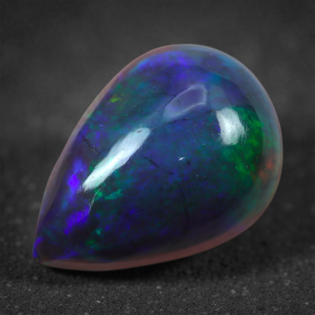 2.70 Carats Natural Welo Origin Smoked Black Opal Cabochon Gems, 14mm, 87M: This natural smoked black opal hails from the Welo region of Ethiopia, a source renowned for producing some of the world's most visually captivating opals. Through a careful and controlled smoking pro