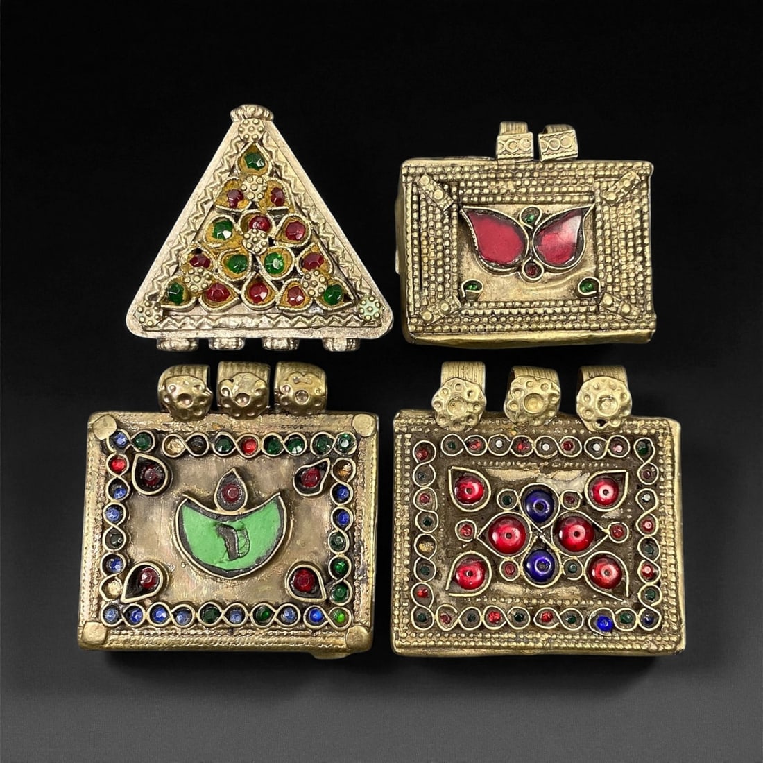 Antique Himalayan Silver Alloy Amulet Box Pendants Set, c. 19th-20th Century, 4.7-5.4 cm, 11EC: This captivating set of four antique Himalayan amulet boxes, dating to the 19th-20th century, represents the region's deep spiritual and artistic heritage. Crafted in silver alloy and richly adorned w