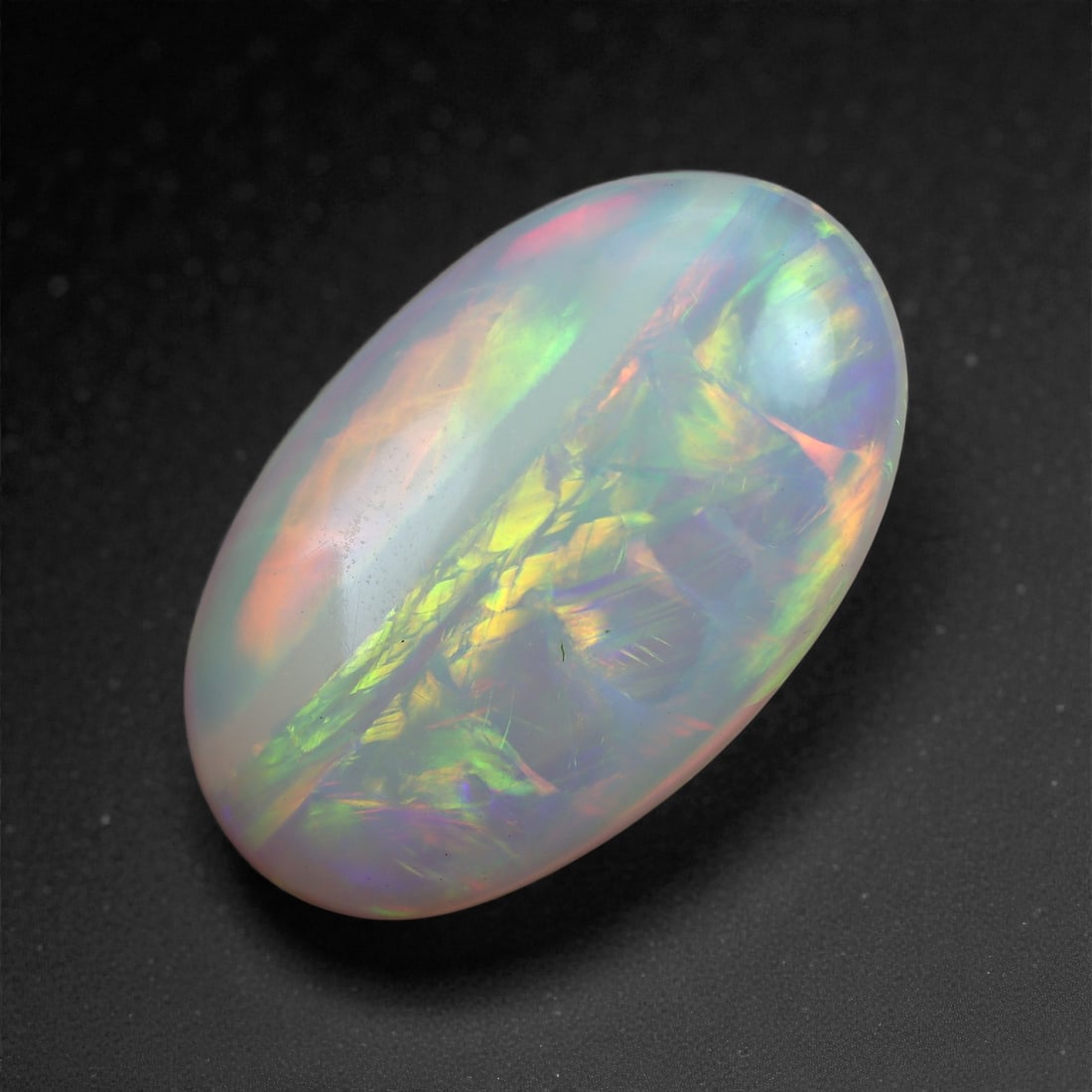 3.82 Carats Play-of-Color Welo Opal - Natural Ethiopian Gem 16x10mm, 21XA: This captivating Welo opal gleams with a luminous cascade of multi neon color that ripple across the stone's surface with every movement. The play-of-color is vivid and well-distributed, presenting a 