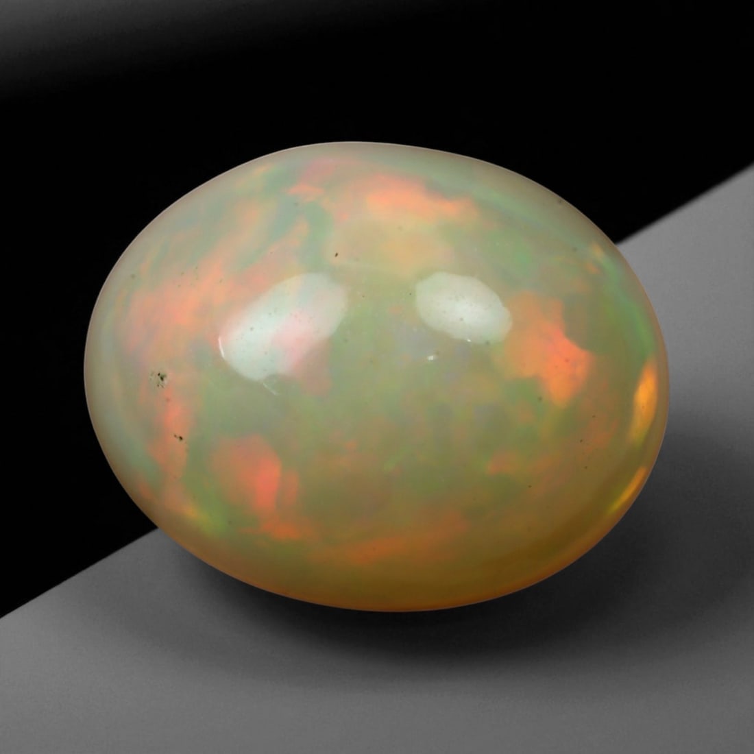 3.90 Carats Multi-Color Welo Opal Lot - Natural Ethiopian Stones, 86WE: This radiant group of Welo opals displays a mesmerizing interplay of color that dances across the surface with every shift of light. Electric flashes of green, orange, and red ripple through a translu