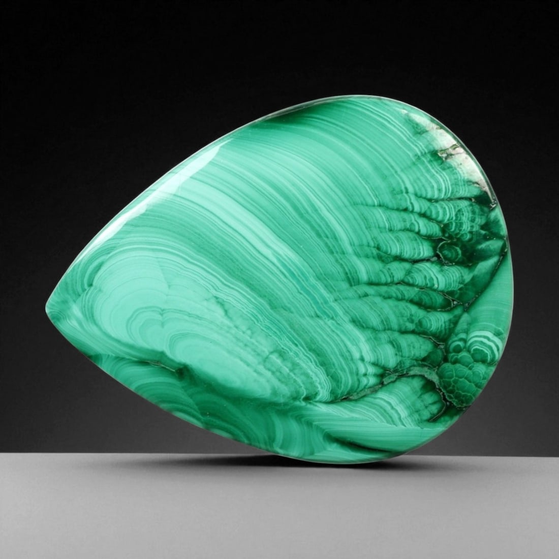 48.67 Carats Banded Forest Green Malachite Pear Cabochon - Natural Congolese Stone, 27WE: This exceptional 48.67-carat malachite cabochon showcases mesmerizing concentric banding in vivid forest and mint green tones. The rhythmic circular patterns flow gracefully across its polished pear s
