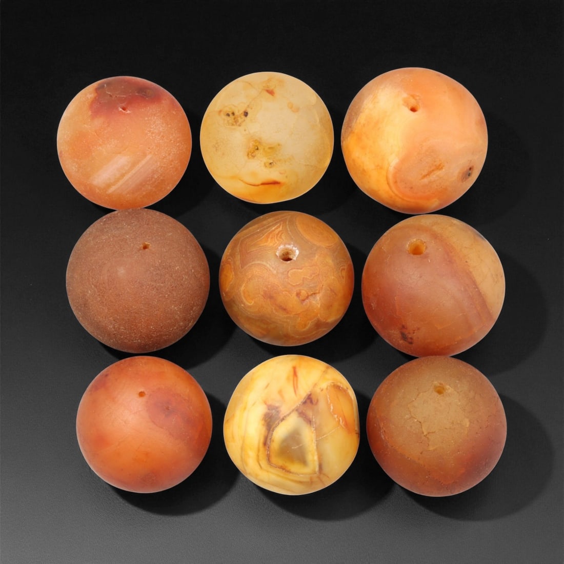 Antique Tibetan Carnelian and Agate Beads, c. 18th-19th Century, 2-2.2cm, 82EF: This fine group of antique Tibetan beads, carved from carnelian and agate, dates to the 18th-19th century. Each spherical bead displays unique natural banding and earthy translucence, ranging in color