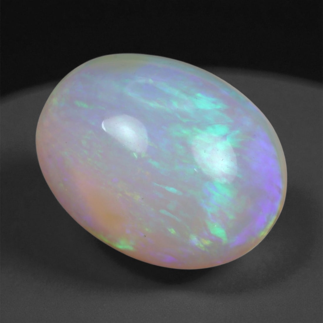 4.71 Carats Multicolor Opal Selection - Natural Welo Ethiopian Stones, 79XB: This luminous selection of Welo opals dazzles with vibrant play-of-color, ranging from electric greens and cobalt blues to sunlit oranges and flashes of violet. Each cabochon has been hand-selected fo