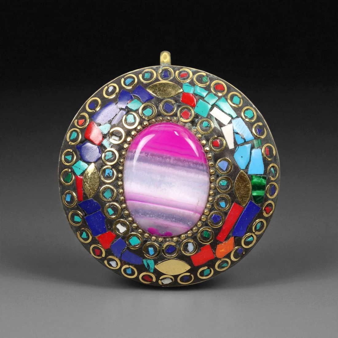 Vintage Himalayan Tribal Mosaic Agate Brass Pendant, 20th Century, 5.5cm, 63XD: This striking round pendant captures the vibrant artistry of 20th-century Himalayan tribal jewelry, blending spiritual symbolism with masterful craftsmanship. At its center rests a polished blue bande