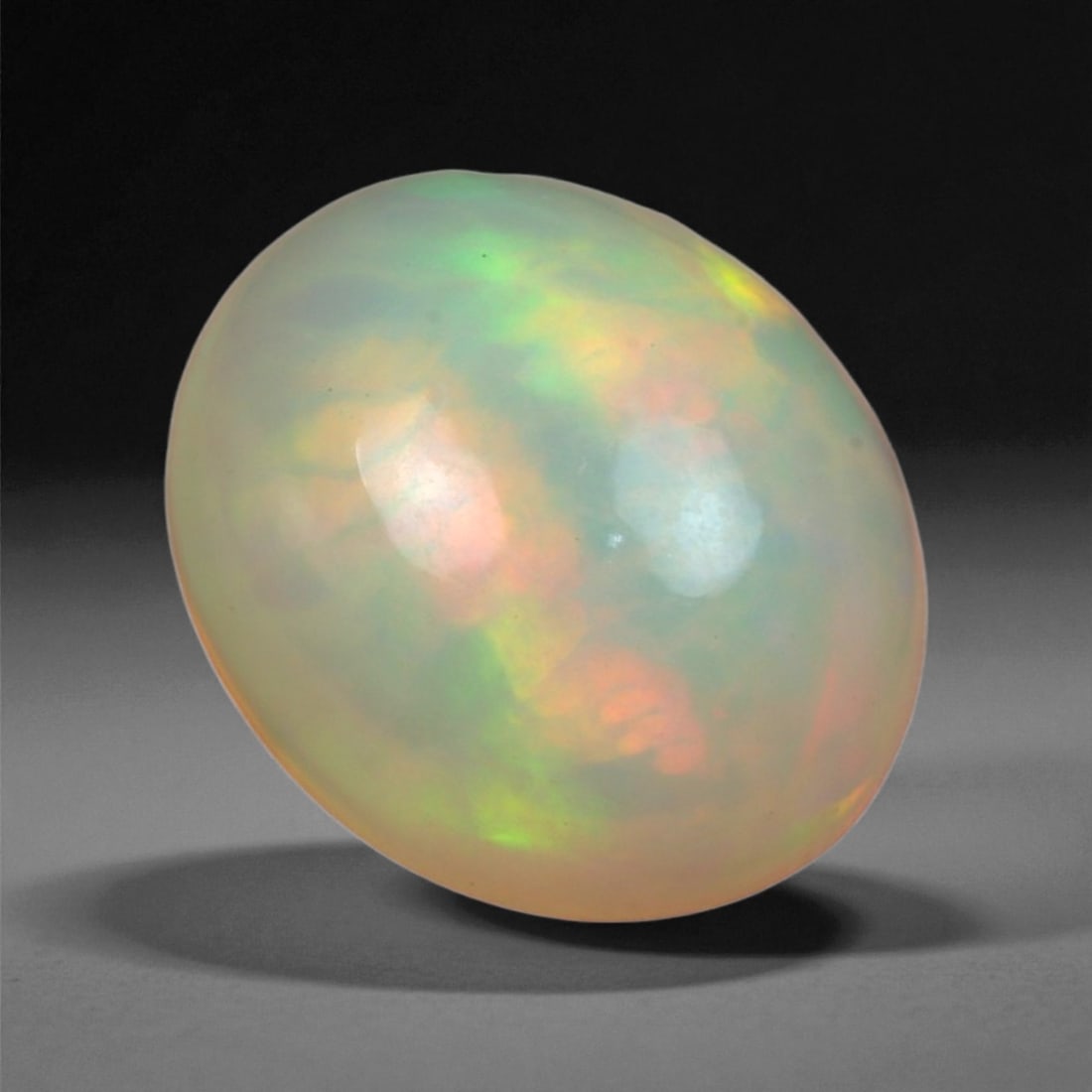 4.35 Carats Multicolor Opal Selection - Natural Welo Ethiopian Stones, 56XB: This luminous selection of Welo opals dazzles with vibrant play-of-color, ranging from electric greens and cobalt blues to sunlit oranges and flashes of violet. Each cabochon has been hand-selected fo