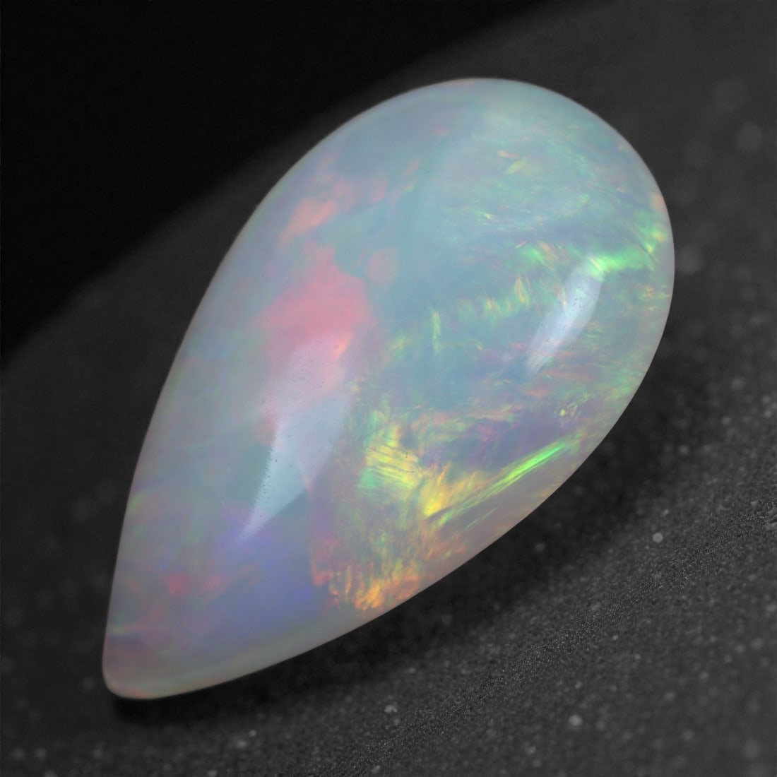2.92 Carats Play-of-Color Welo Opal - Natural Ethiopian Gem 15x9mm, 93XA: This captivating Welo opal gleams with a luminous cascade of multi neon color that ripple across the stone's surface with every movement. The play-of-color is vivid and well-distributed, presenting a 