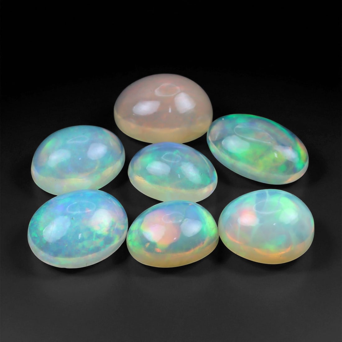 10.01 Carats Neon Play-of-Color Opal Selection - Natural Ethiopian Cabochons - 8 to 10 mm, 92XE: This luminous selection of opals radiates a dynamic spectrum of neon hues, with flashes of electric green, vivid orange, and spectral blue dancing across each dome. Their translucent base allows the i