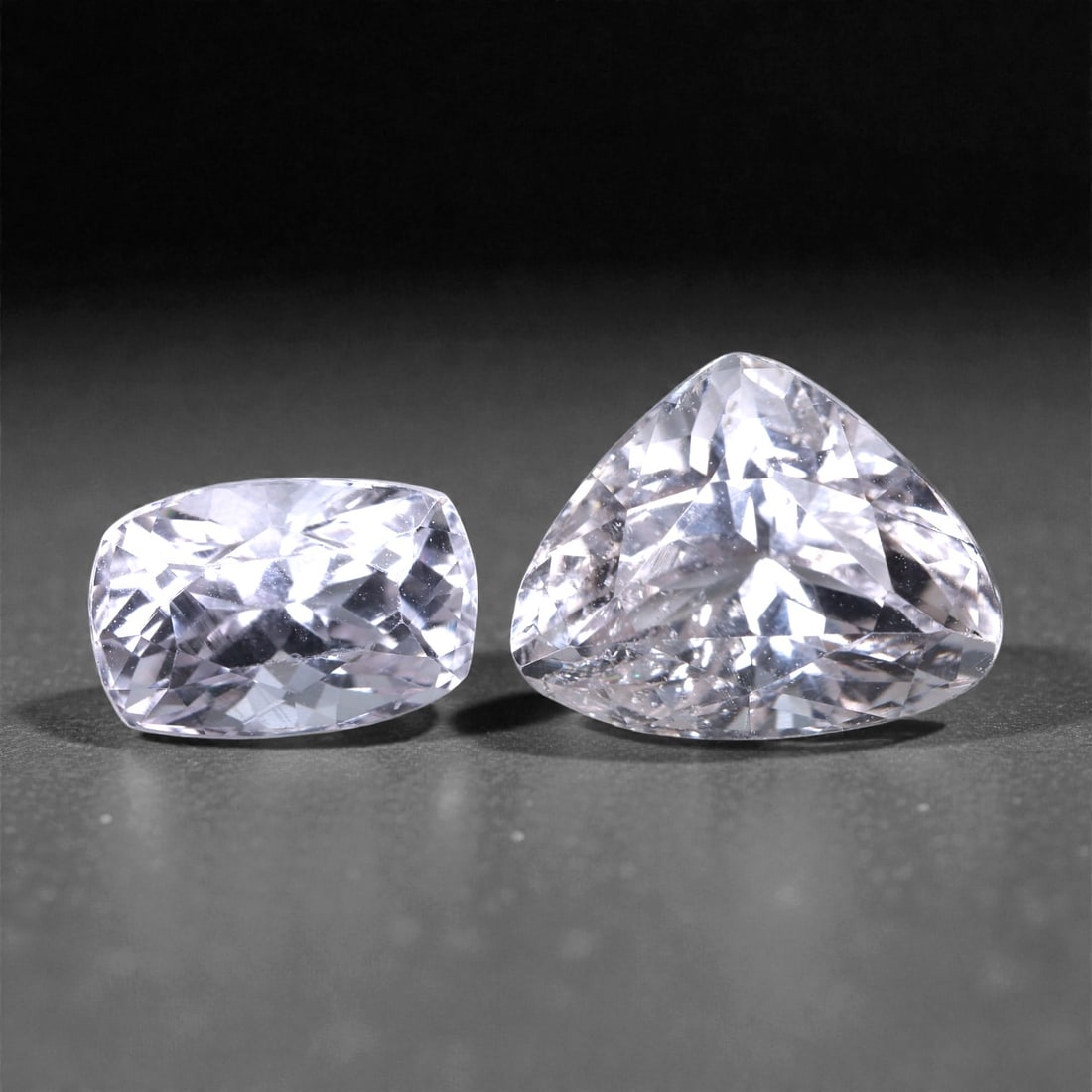 7.50 Carats Light Pink Kunzite Pair - Natural Afghan Stones, 5XC: This elegant 7.50 carat kunzite pair showcases refined pastel beauty across two distinct cuts-one a well-proportioned trillion, the other a softly elongated cushion. Ranging from 9 to 13 mm, both gems