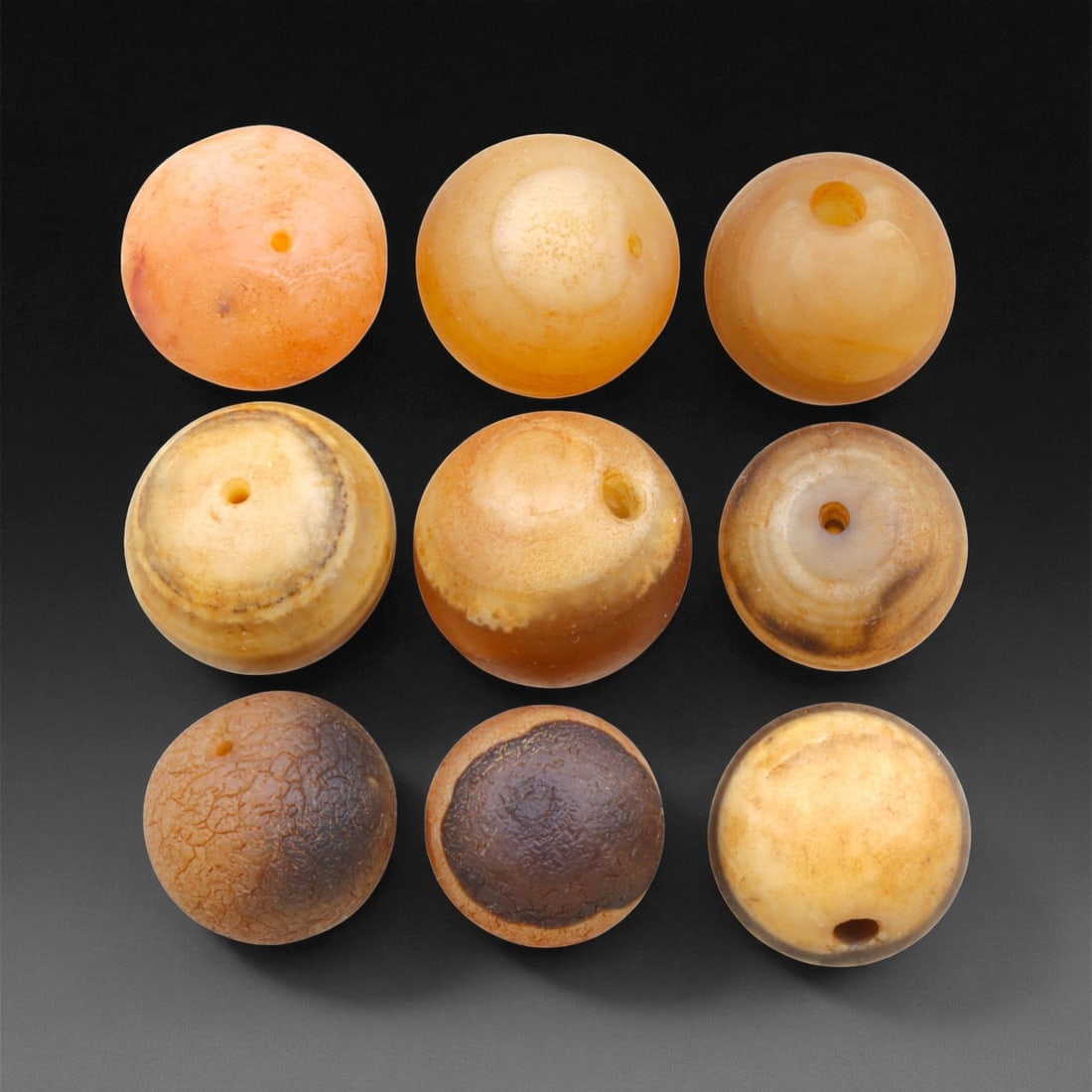 Antique Tibetan Carnelian Beads Collection, c. 18th-19th Century, 1.3-1.5cm, 100EL: This collection of antique Tibetan carnelian beads, dating to the 18th-19th century, exemplifies the spiritual and artisanal refinement of Himalayan lapidary traditions. Each bead, hand-shaped from na