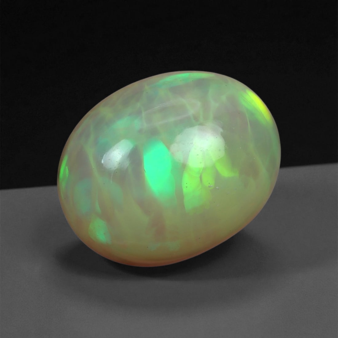 5.56 Carats Multicolor Opal Selection - Natural Welo Ethiopian Stones, 40XB: This luminous selection of Welo opals dazzles with vibrant play-of-color, ranging from electric greens and cobalt blues to sunlit oranges and flashes of violet. Each cabochon has been hand-selected fo