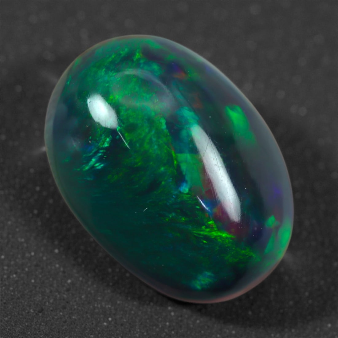 2.30 Carats Natural Welo Origin Smoked Black Opal Cabochon Gems, 12mm, 65M: This natural smoked black opal hails from the Welo region of Ethiopia, a source renowned for producing some of the world's most visually captivating opals. Through a careful and controlled smoking pro